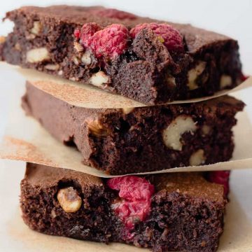 Gluten-free raspberry brownies on a table.