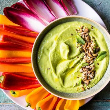 Green pea hummus with olive oil and seeds.