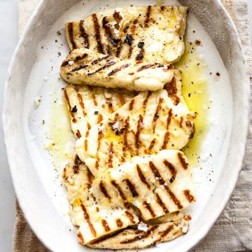 Grilled halloumi with pepper in a white plate.