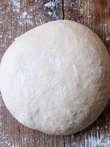 Ball of best Italian Pizza dough on a wood board.