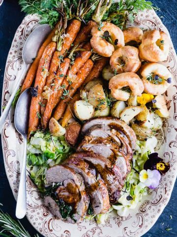 Roasted lamb shoulder with roast potatoes and carrots.