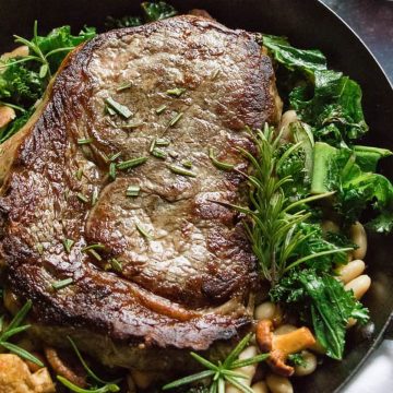 Seared rib-eye steak with mushrooms.
