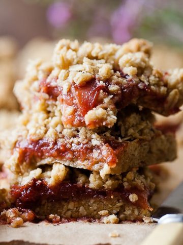 Strawberry rhubarb crumble bars on a table.