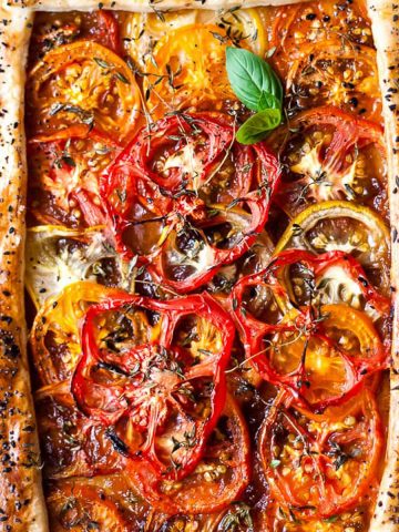 Tomato tart with seeds in a puff pastry crust.