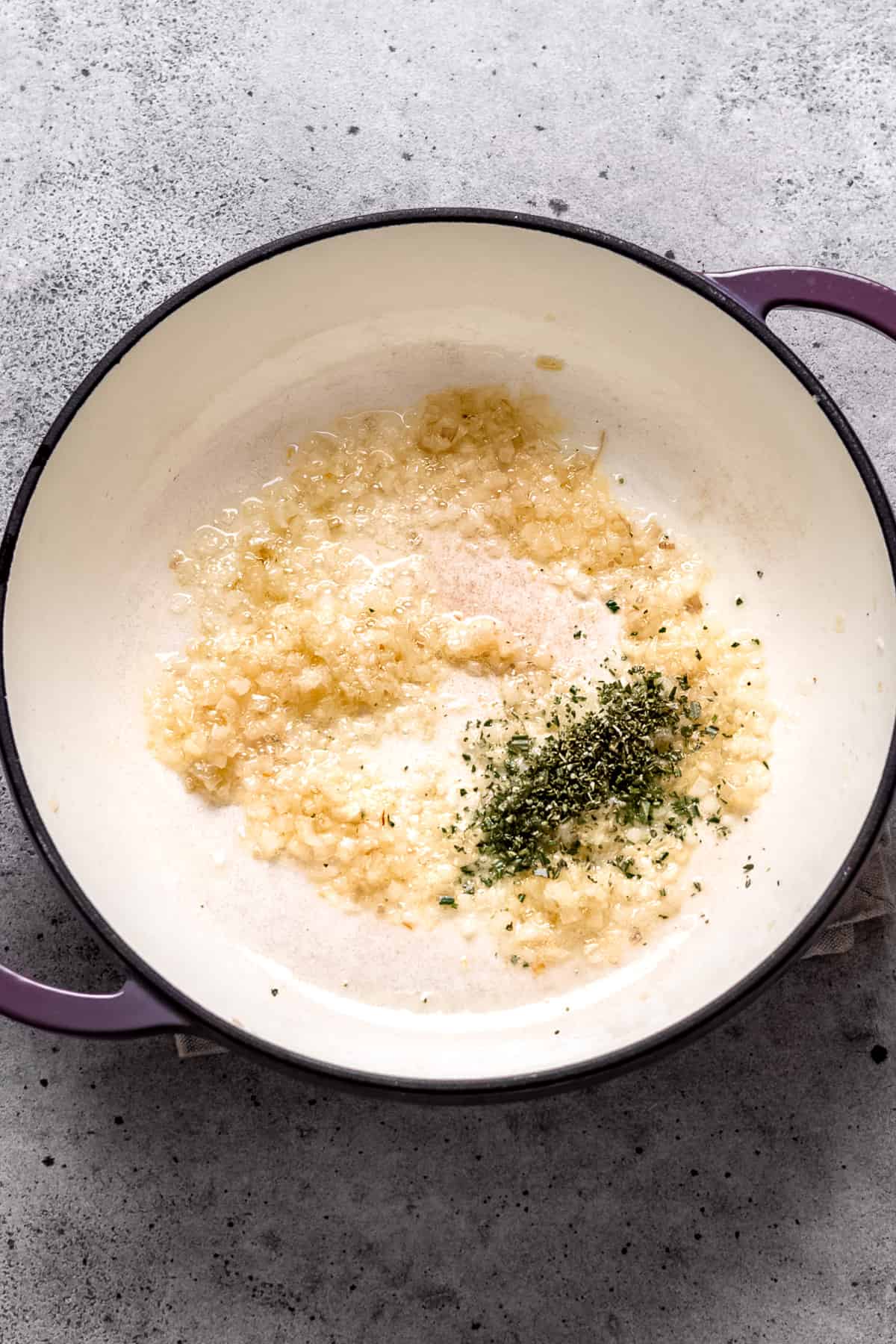 Onions and herbs are being cooked for meatball sauce.