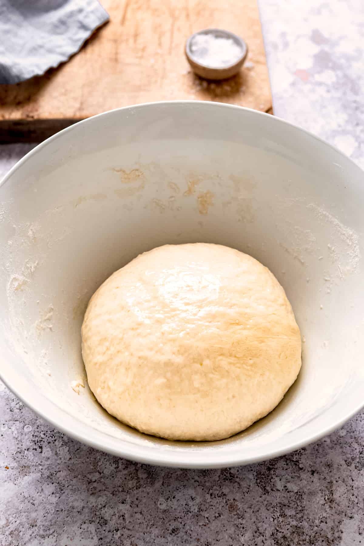 Pizza dough left to rise in a bowl.