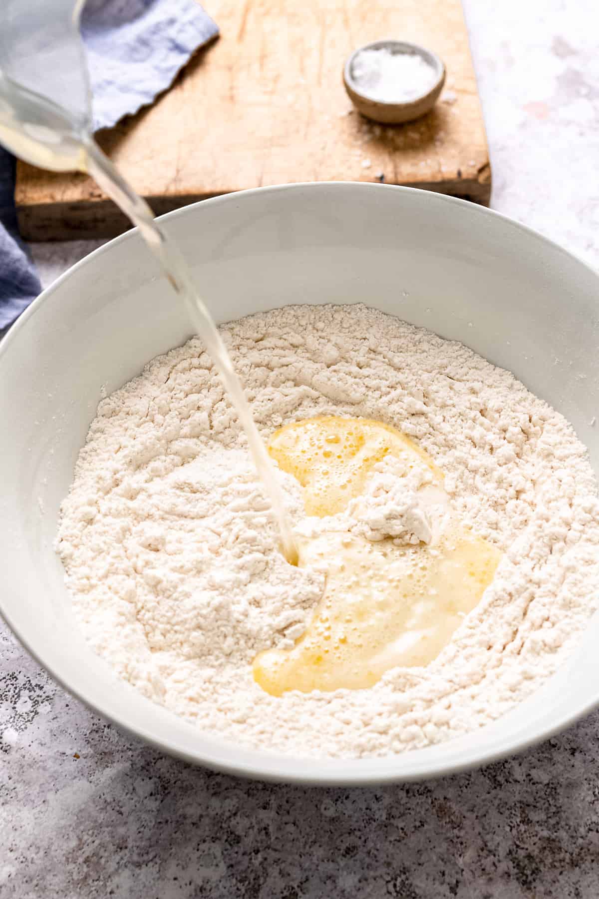 Water and yeast being added to flour.