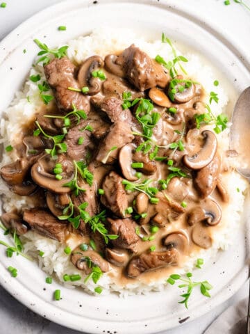 Rich beef stroganoff on a white plate.