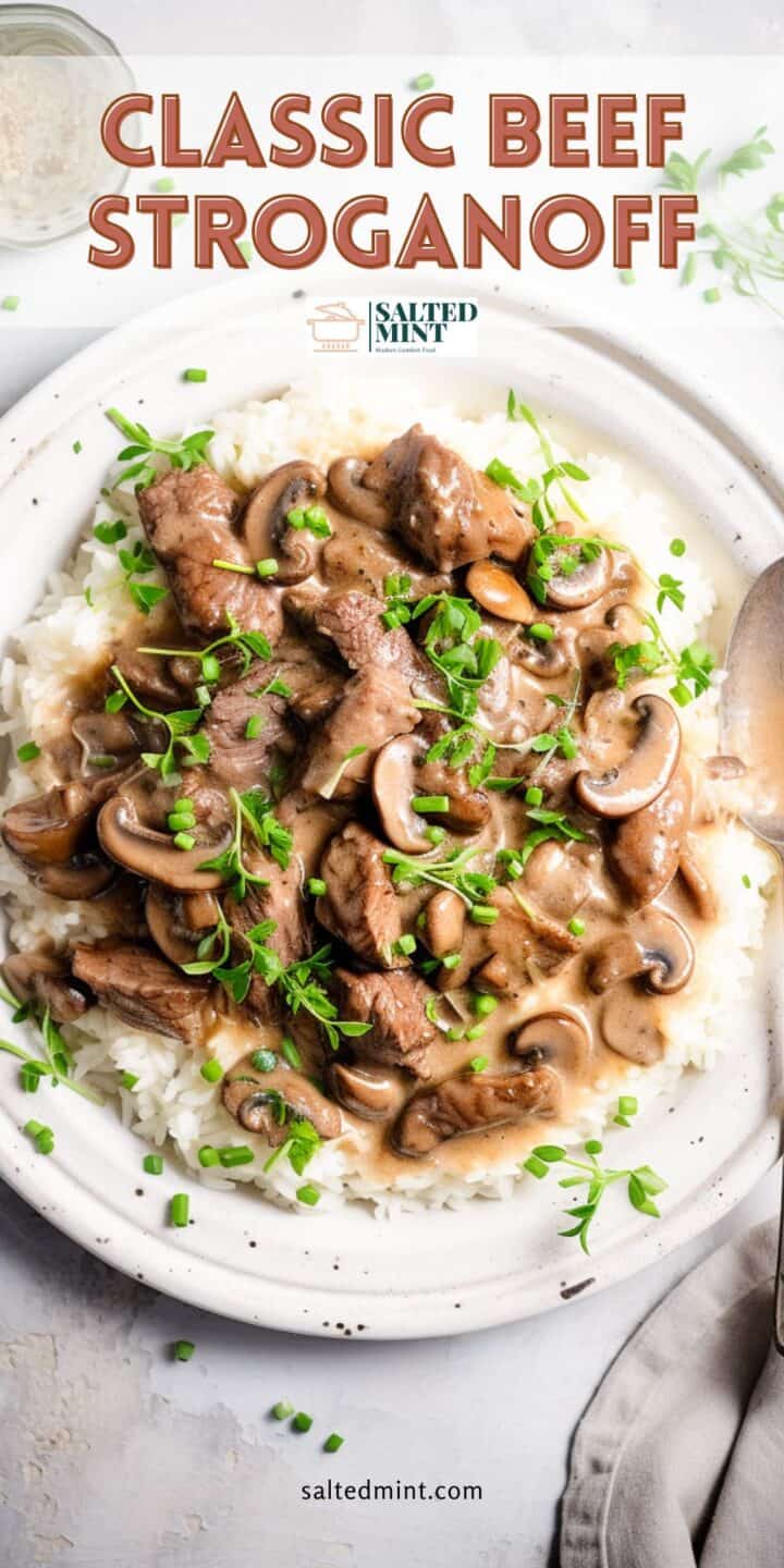 Rich beef stroganoff on a white plate with text overlay.