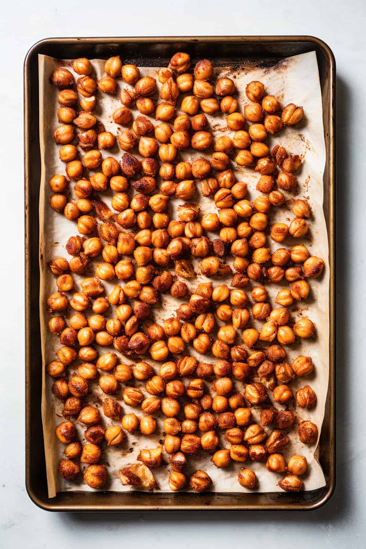 Roasted chickpeas on a baking tray.