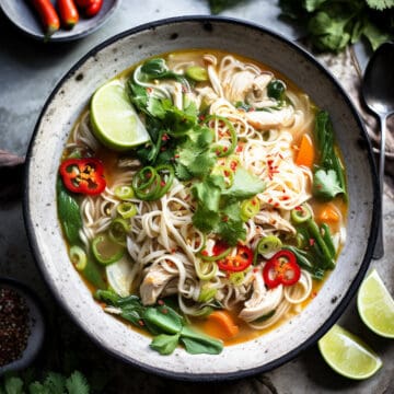 Asian chicken noodle soup with carrots and vegetables.