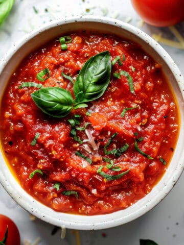 Pomodoro sauce in a white bowl with basil.