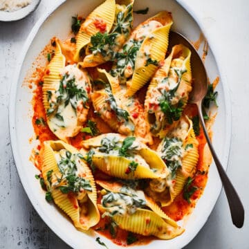 Ricotta stuffed shells with spinach and tomato sauce.