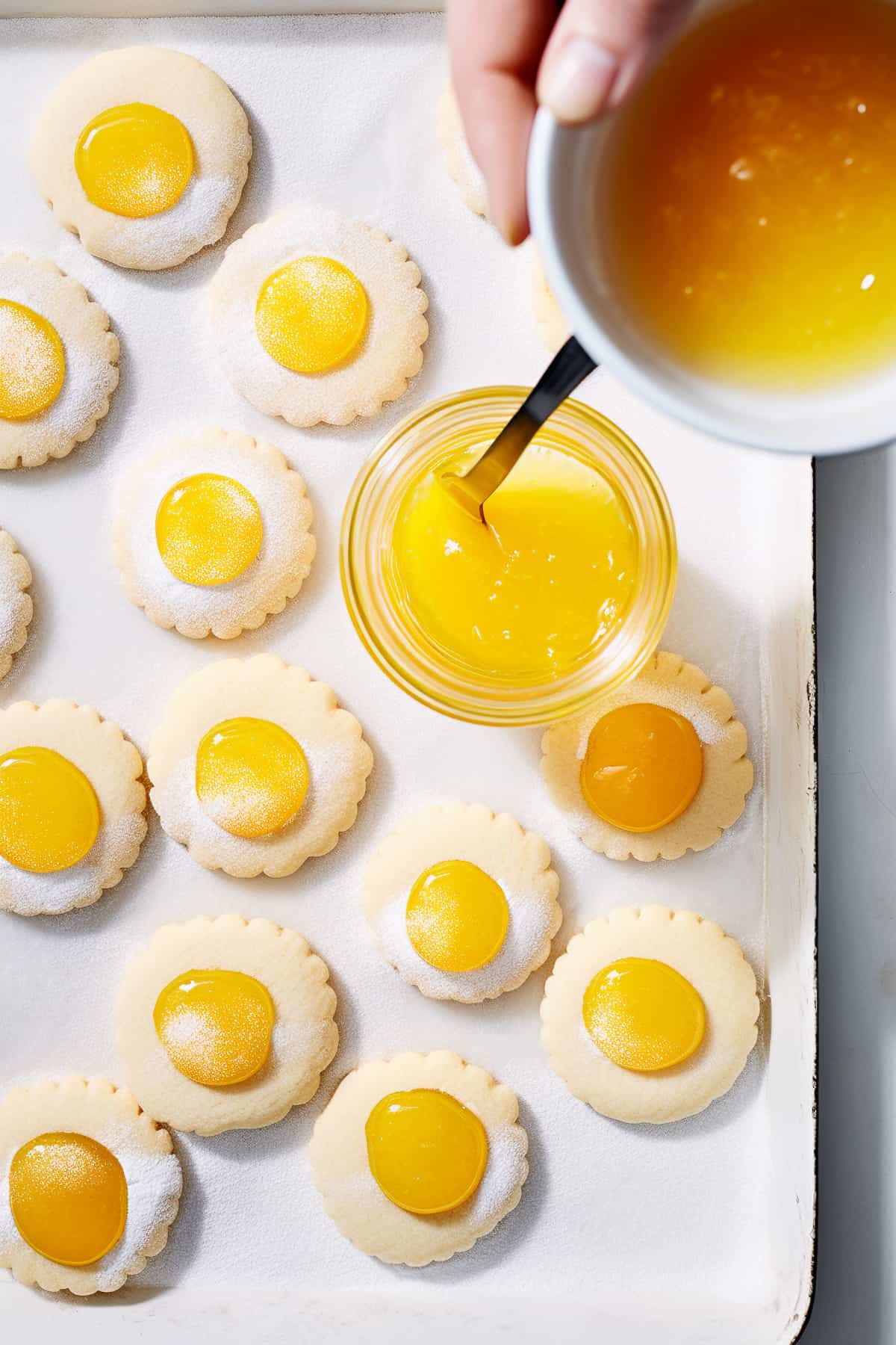 Filling thumbprint cookie with lemon curd.