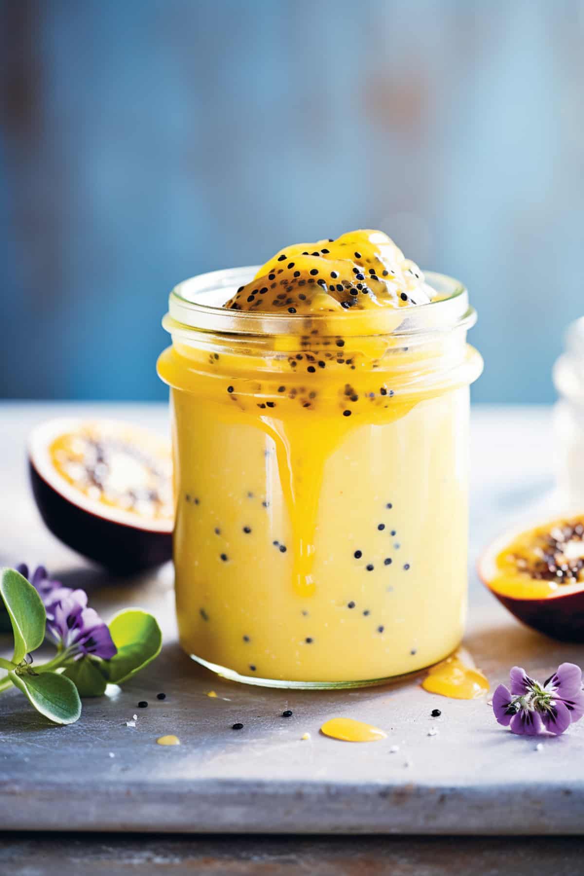 Passion fruit curd in a jar on a table.