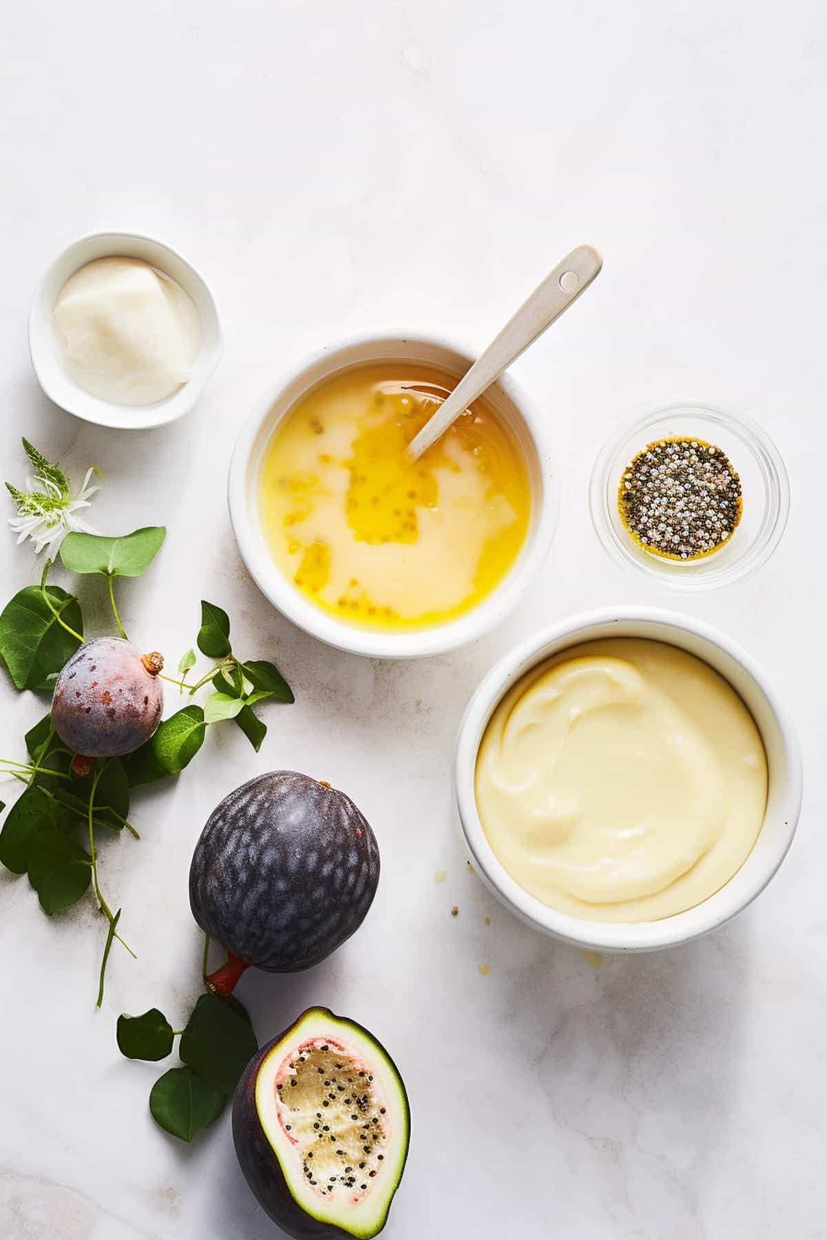 Ingredients for passion fruit curd on a white table.