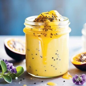 Passion fruit curd in a jar on a table.