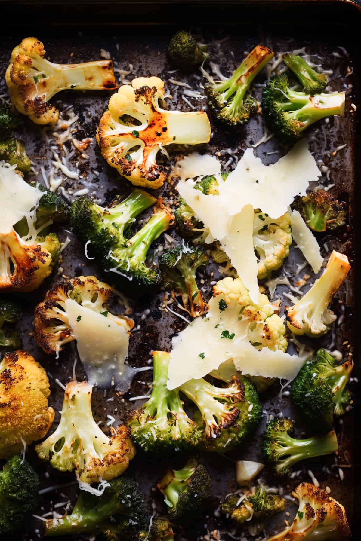 Roasted Cauliflower and Broccoli with parmesan on a baking tray.