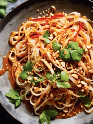 Thai peanut noodles with peanut sauce in a bowl.
