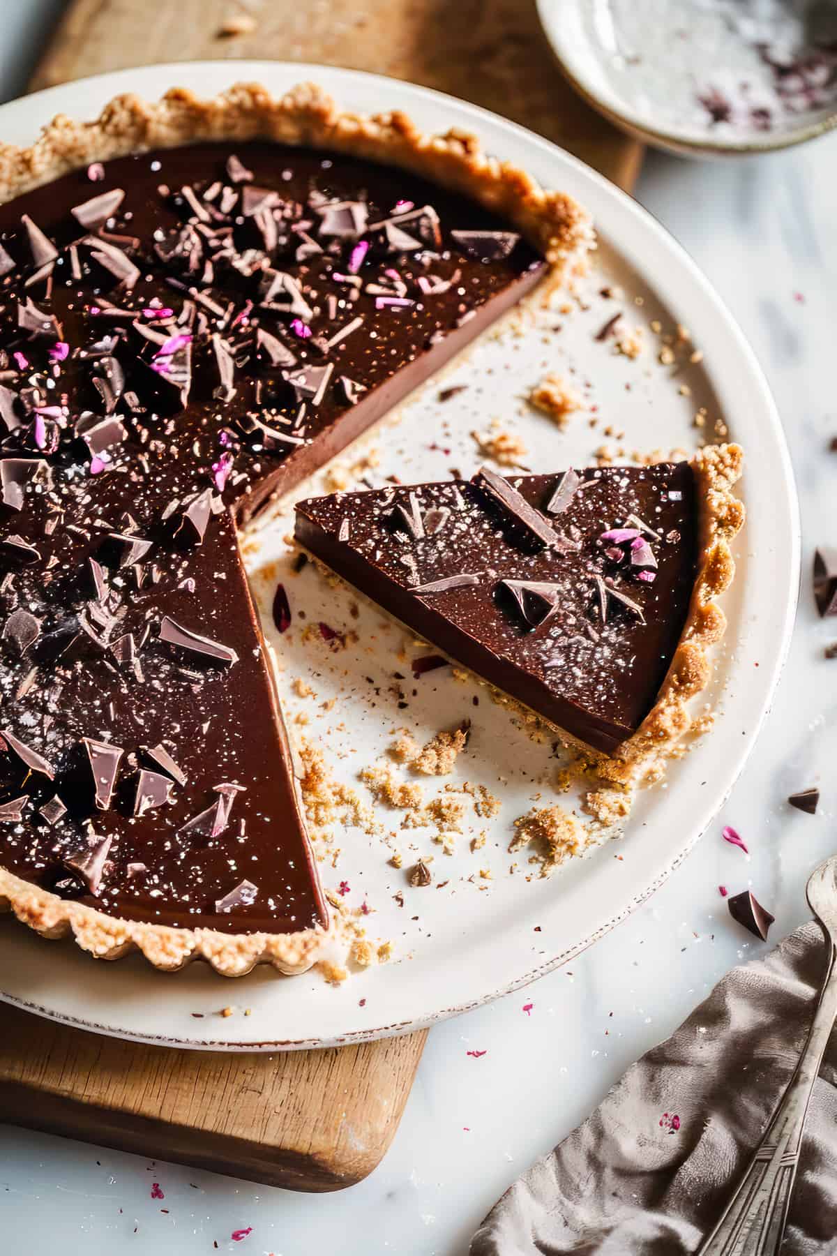Easy ganache tart in a pastry crust on a white plate.