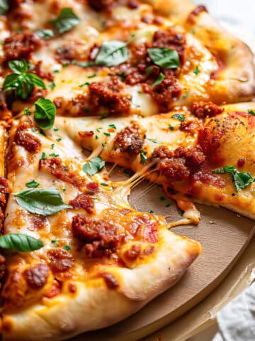 Chorizo pizza with cheese and basil.