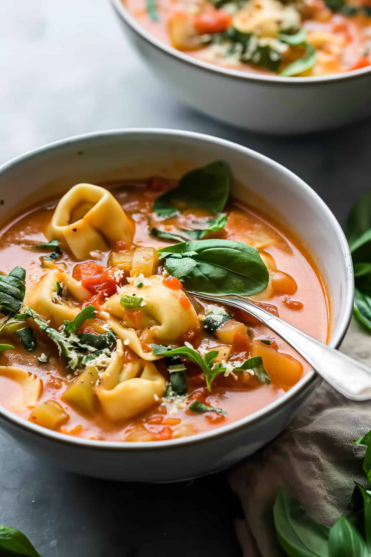 Creamy tomato tortellini soup with parmesan and basil.