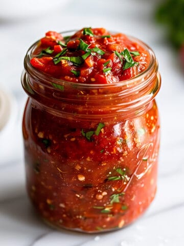 Homemade Arrabbiata pasta sauce in a glass jar.