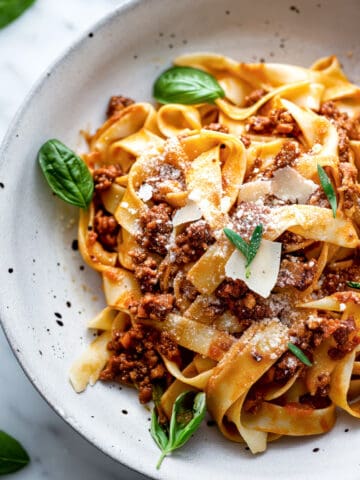 Easy Bolognese spaghetti with parmesan cheese and fresh basil.