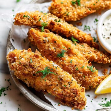 Panko-crusted oven-baked chicken tenders with dipping sauce.