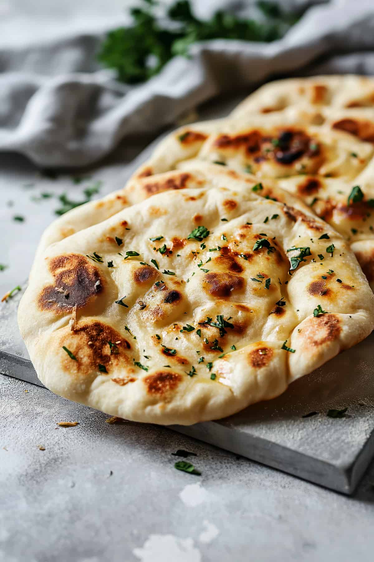 Easy garlic naan bread on a chopping board.