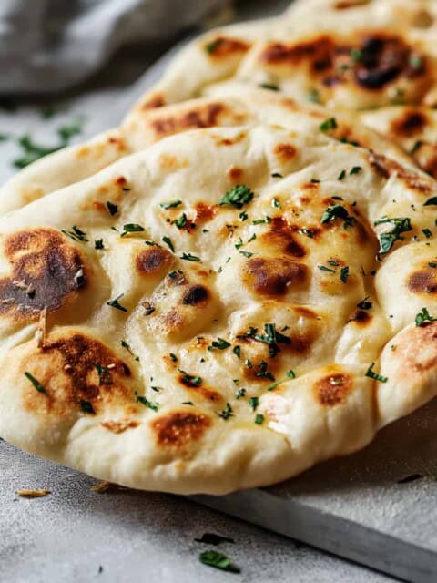 Easy garlic naan bread on a chopping board.