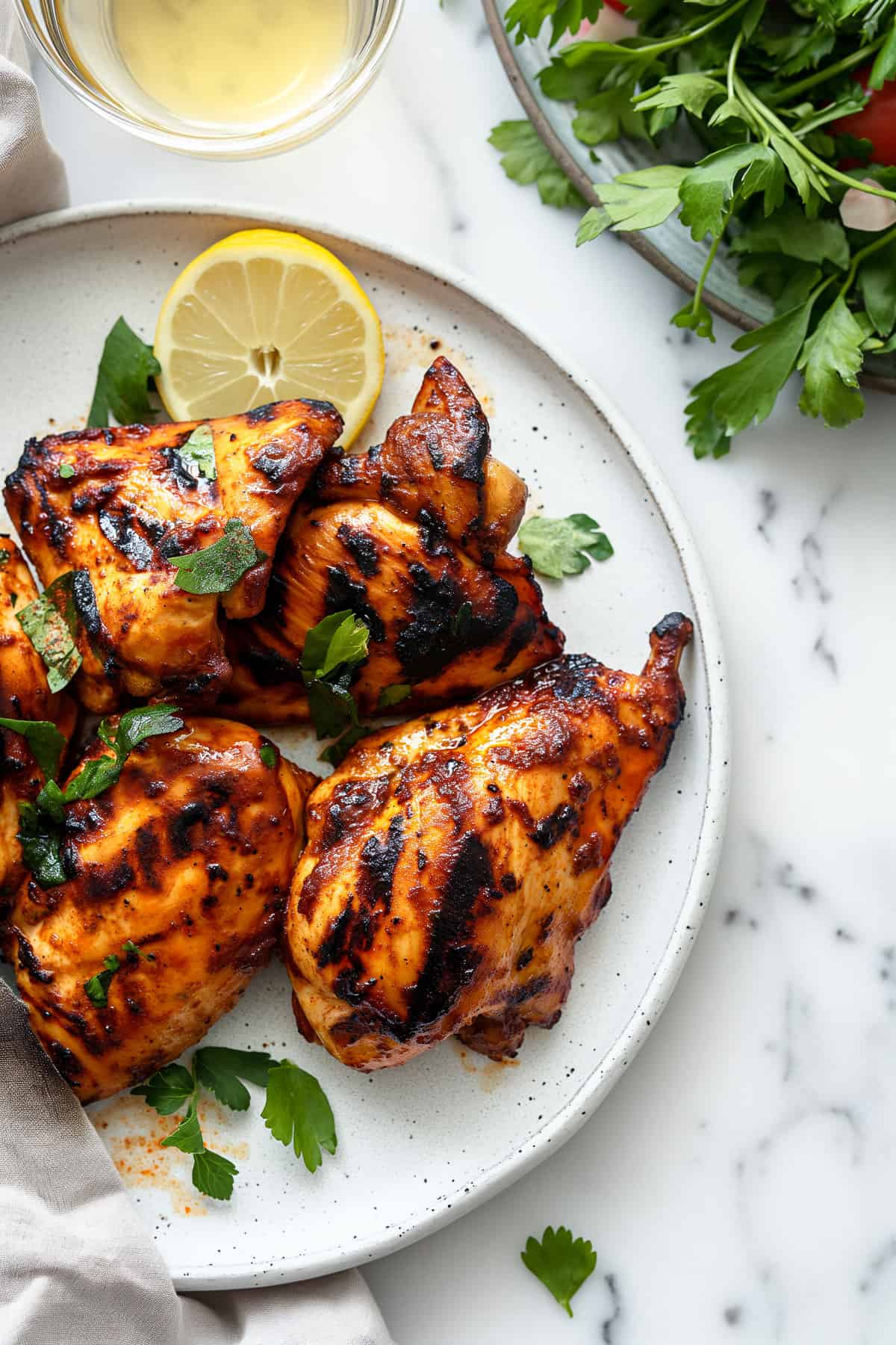 Grilled Moroccan chicken on a white plate.