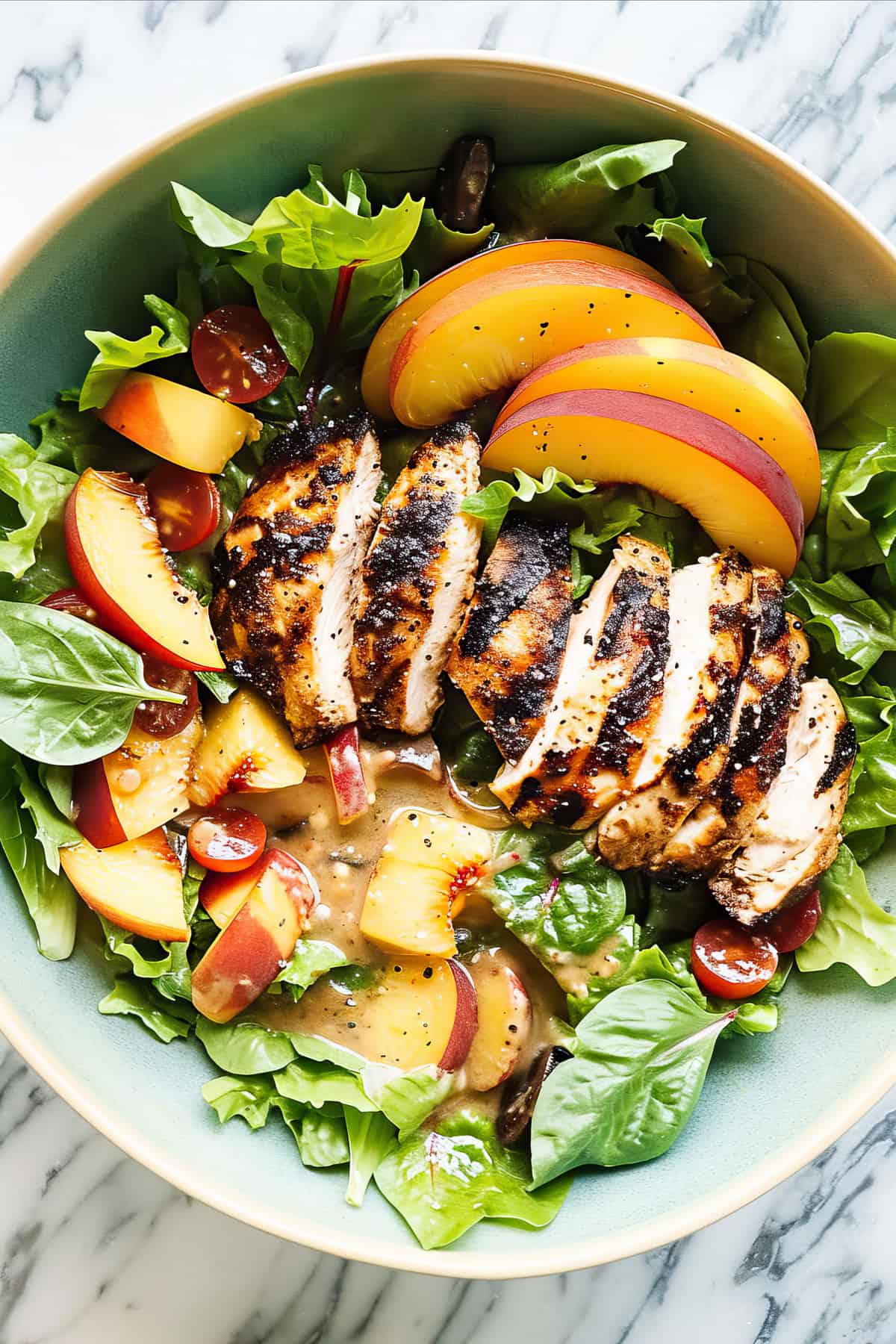 Maple chicken grilled with peaches and salad with vinaigrette dressing.