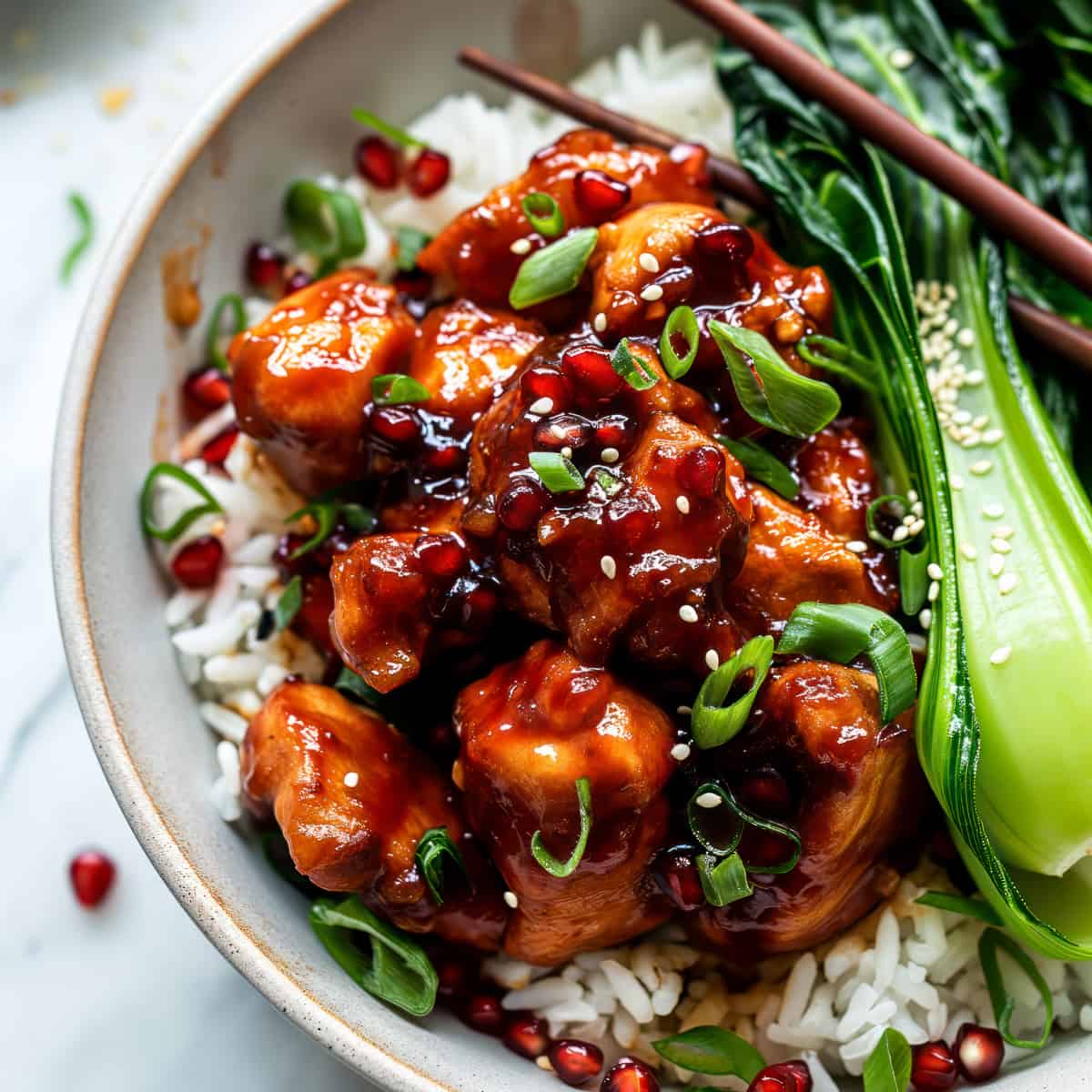 Easy sticky pomegranate chicken over rice.