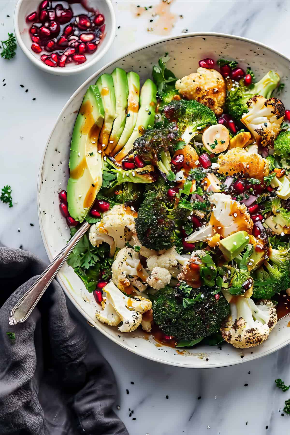 Warm roasted broccoli winter salad with vinaigrette dressing in a white bowl.
