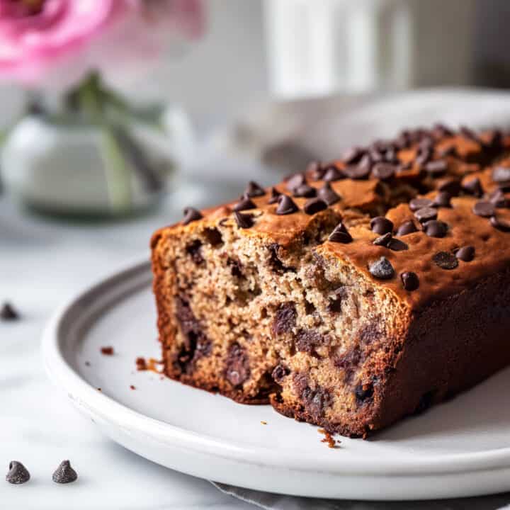 Chocolate chunk banana bread on a white plate.
