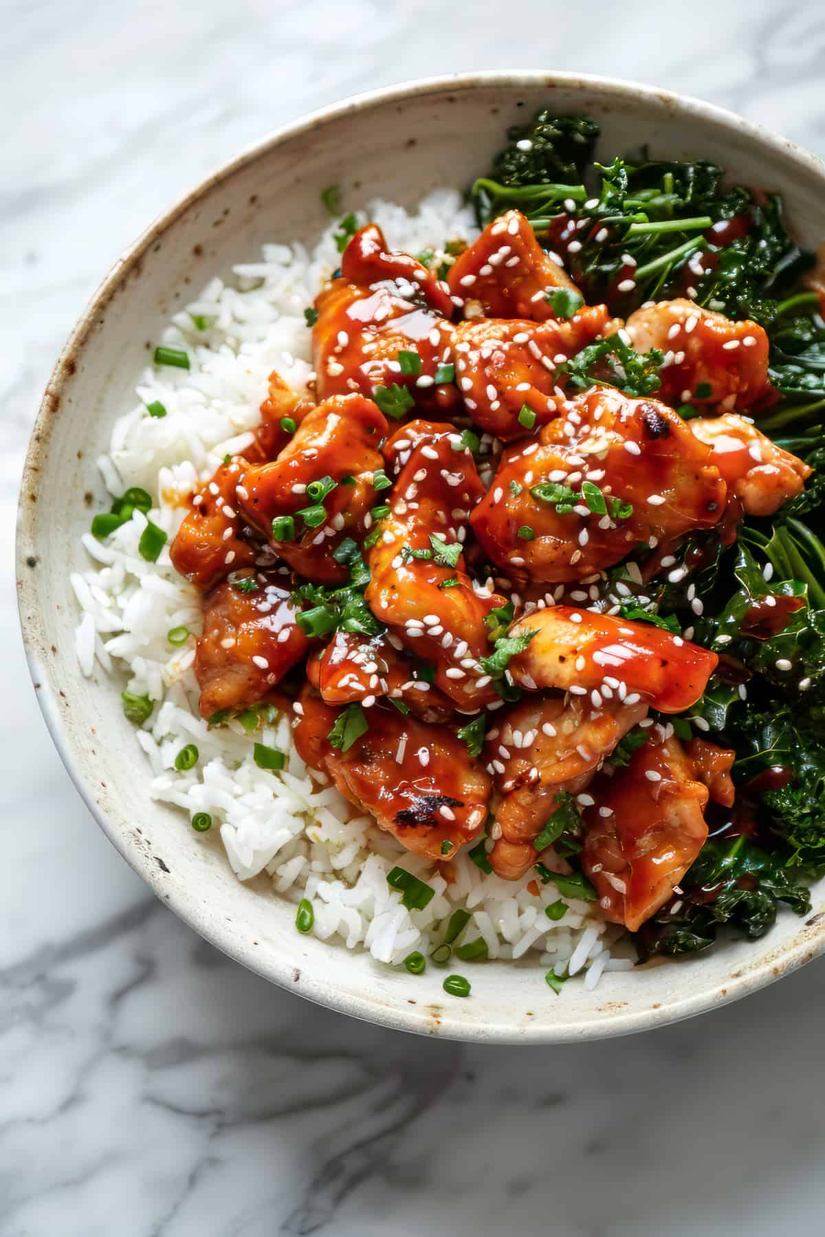 Easy spicy Korean chicken with rice in a white bowl.