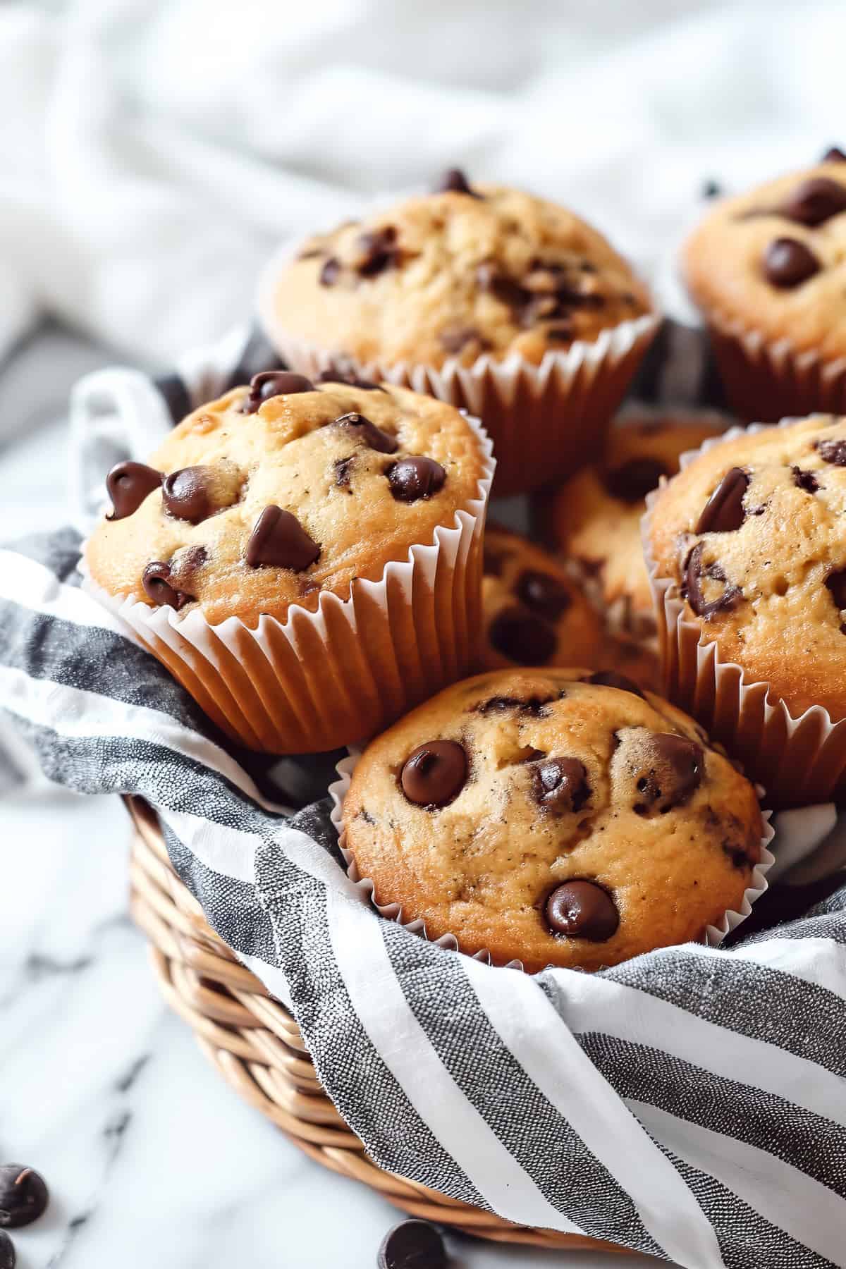Chocolate chip banana bread muffins in a basket.