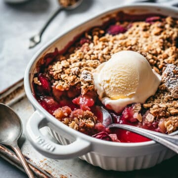 Fruit crisp with ice cream in a baking dish.