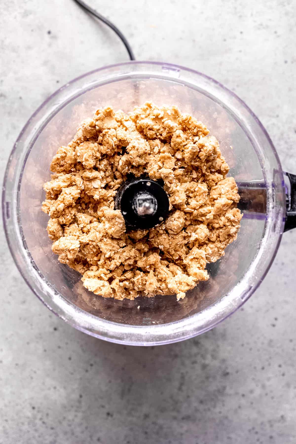 Oat and butter in a food processor for making crumble topping.