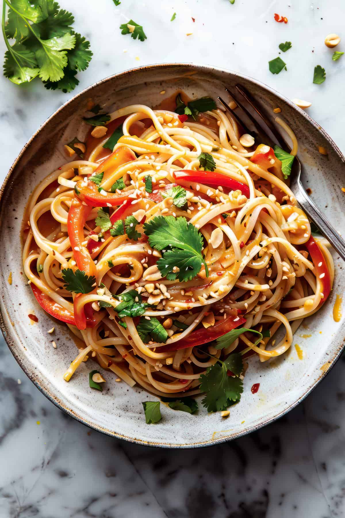 Thai peanut noodles with peanut sauce in a bowl.