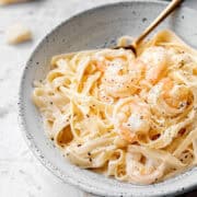 Creamy shrimp pasta in a bowl with parmesan.