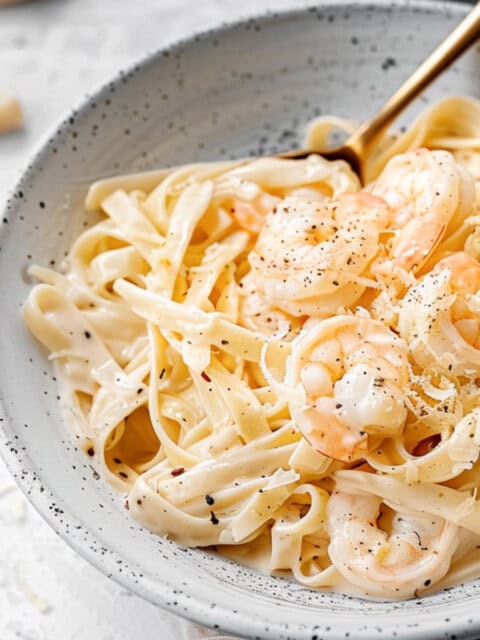 Creamy shrimp pasta in a bowl with parmesan.