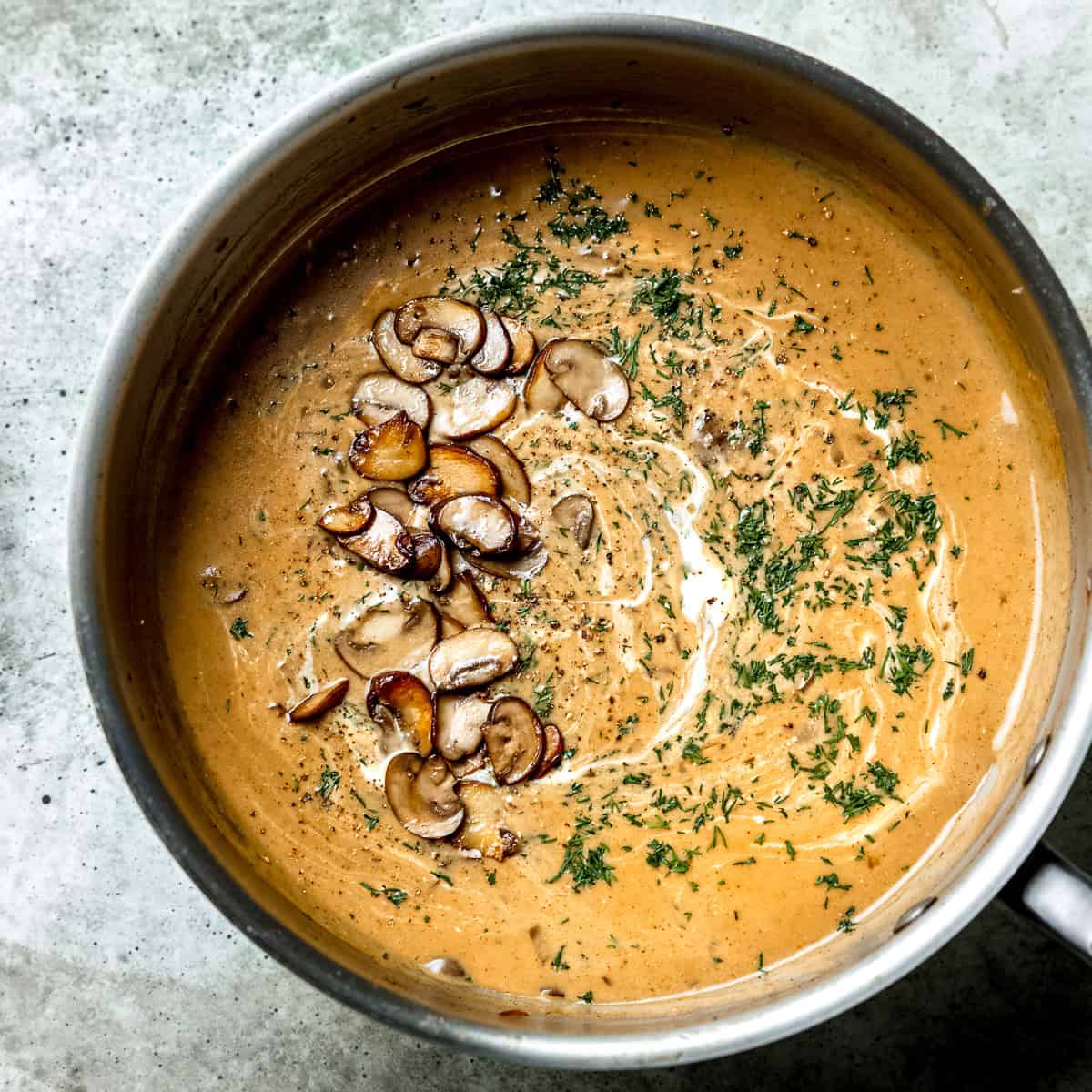 Hungarian mushroom soup with cream and parsley.
