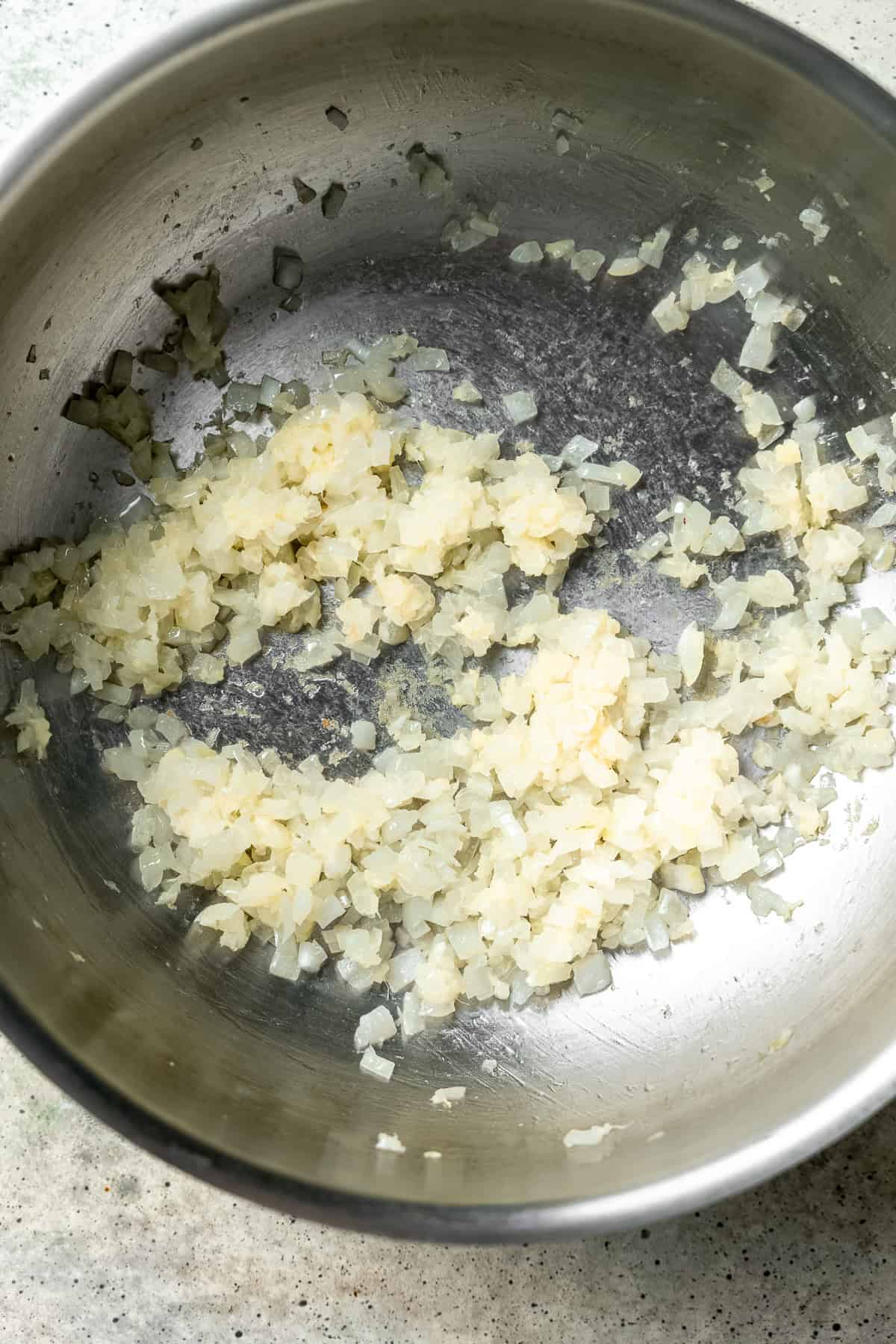 Sautéing the onions and garlic for dumpling soup.