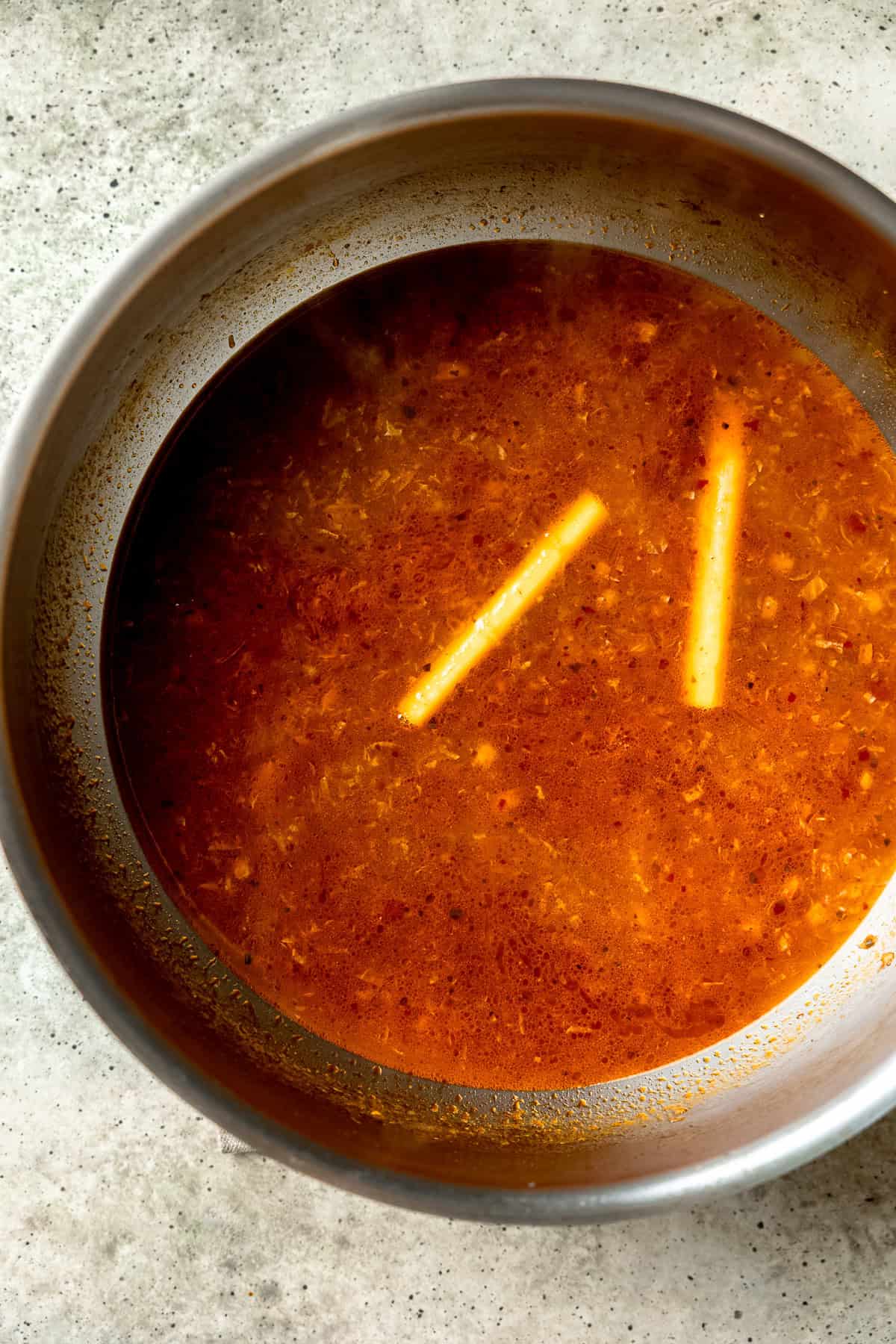 Stock being added to broth base for dumpling soup.