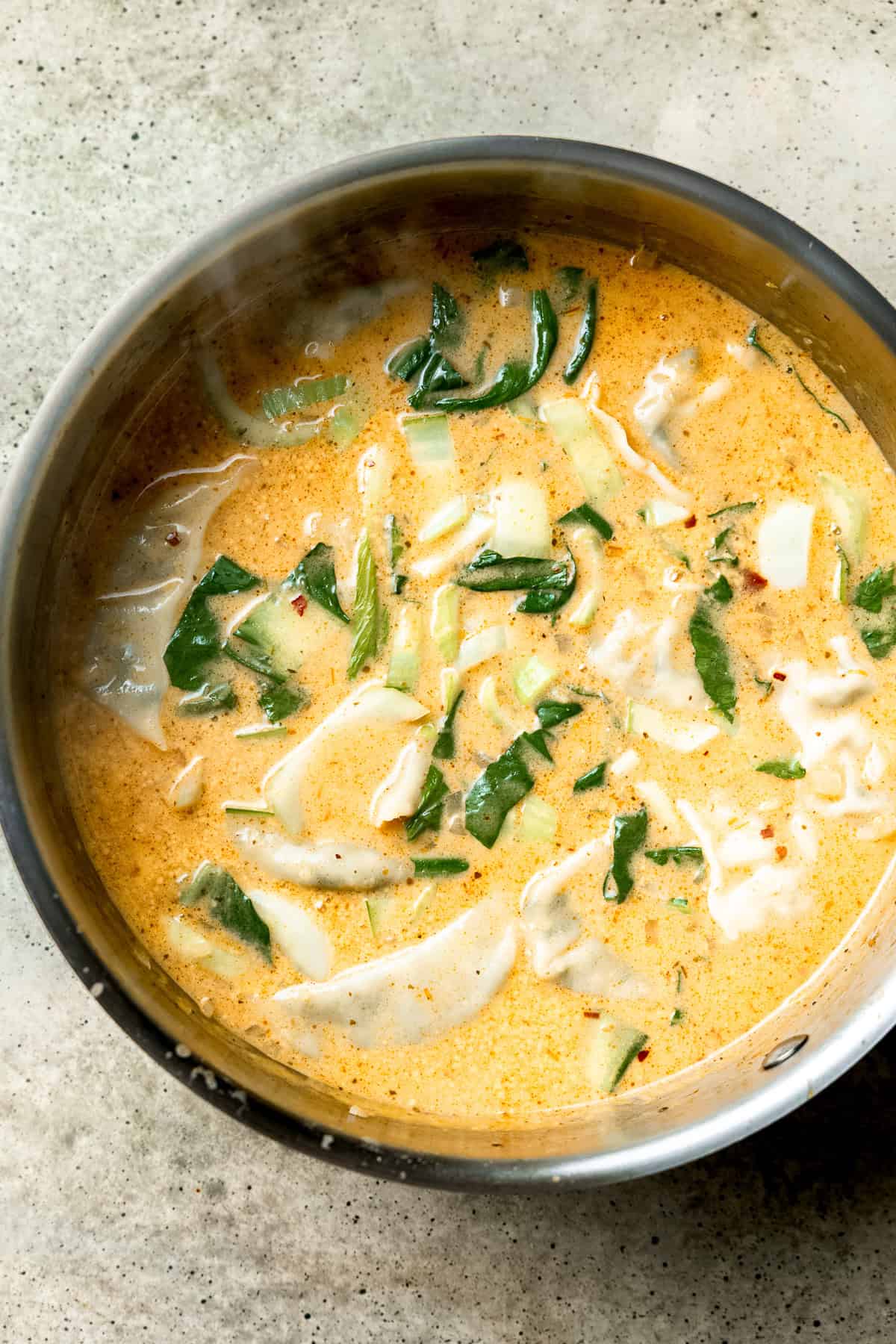 Dumplings being added to Thai dumpling soup.