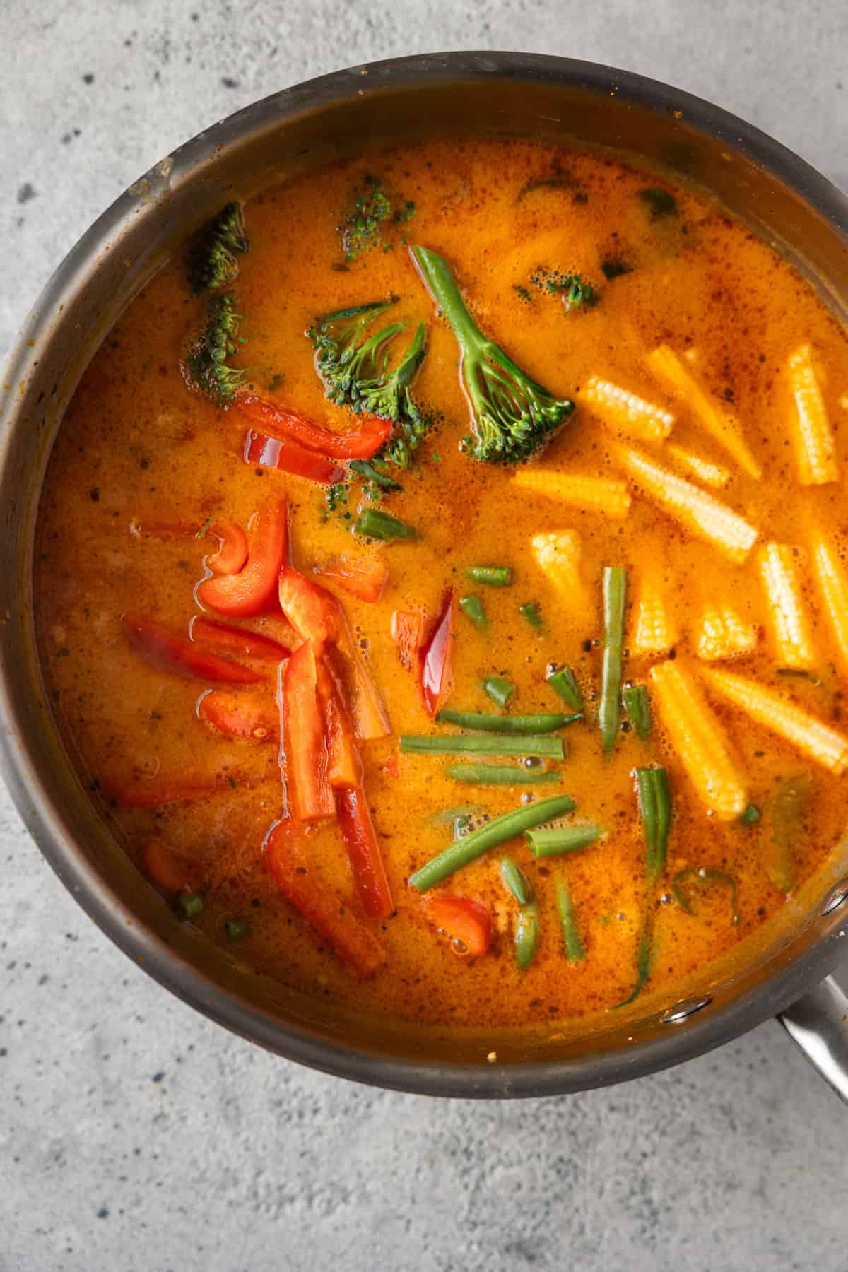 Chicken and vegetables simmering in the Thai curry sauce.