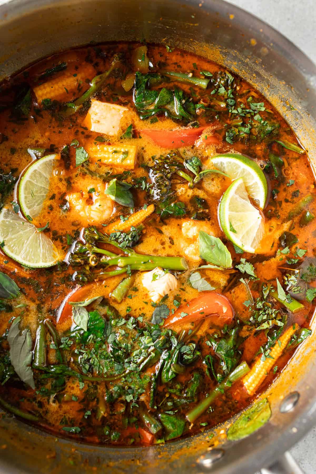 Close up of Thai red curry in the pan with basil.