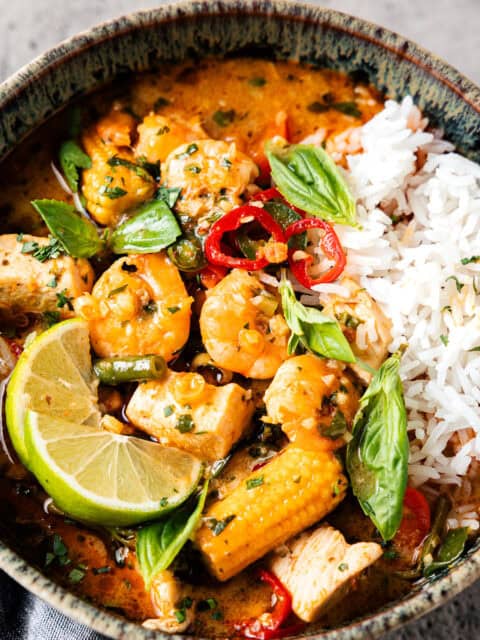 Thai red curry in a bowl with vegetables and chicken.